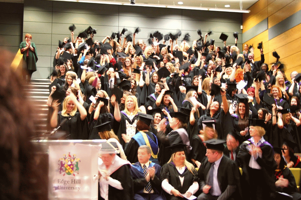 Nursing Students waving their caps in a blur