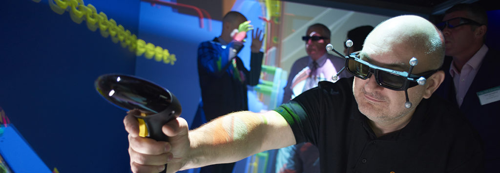 Person operating the latest VR equipment in an immersive environment (the CAVE) within the University Tech Hub.