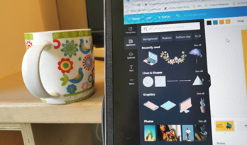A cup of tea on a desk next to a laptop on the web application Canva.