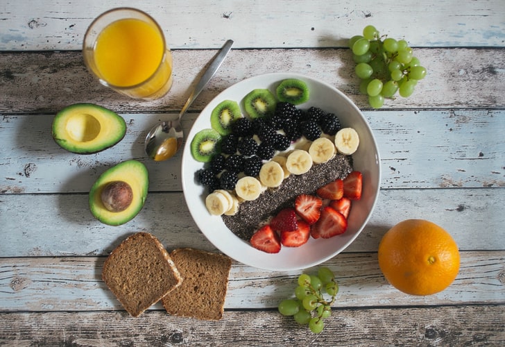 Photograph of a breakfast table with a variety of food. 