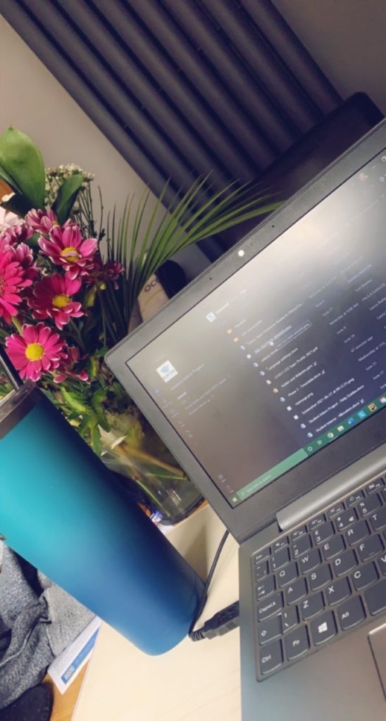 A picture containing a water bottle and a laptop displaying teams 