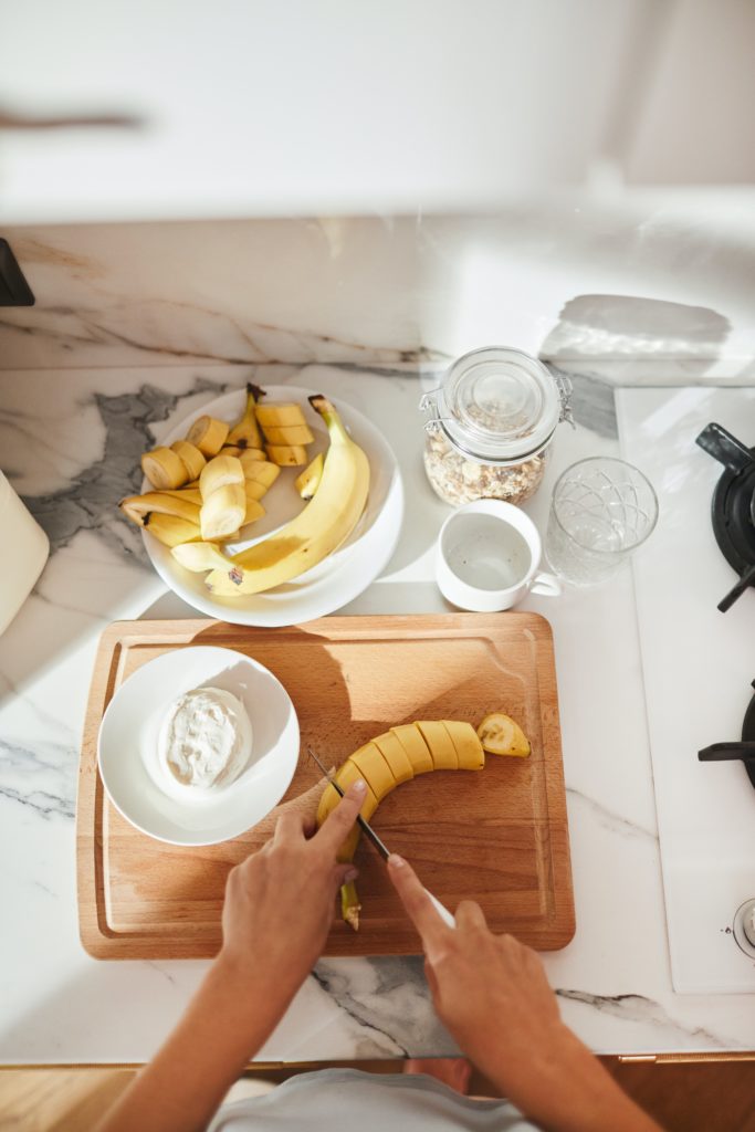 hands preparing a banana 