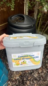 Compost caddy in front of garden compost bin. 