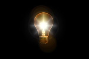 A light bulb illuminating a dark space