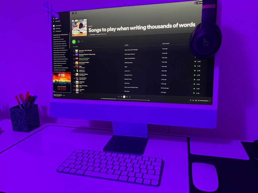 a computer in a purple-lit room