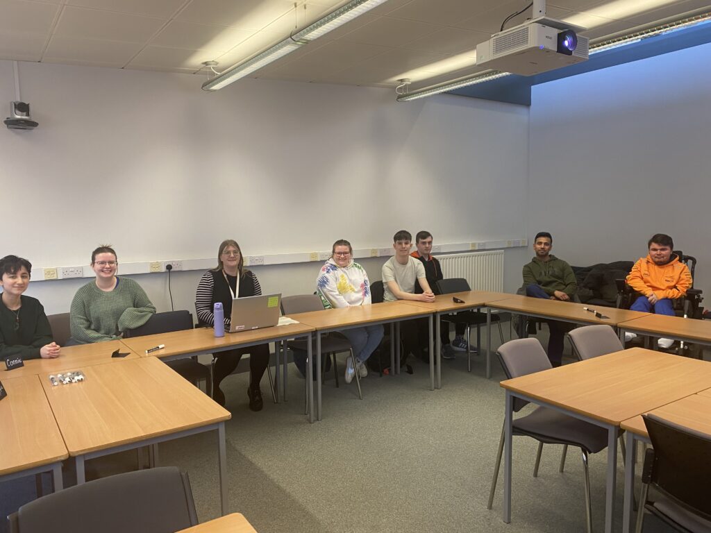 Panel members sitting around a table at a panel